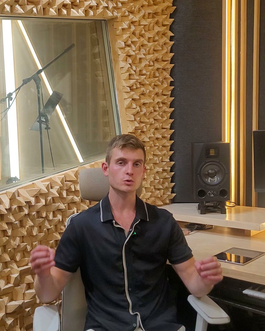 Dennis Ksendzov talking to camera in the sound booth